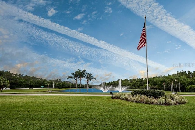 view of property's community featuring a water view and a yard