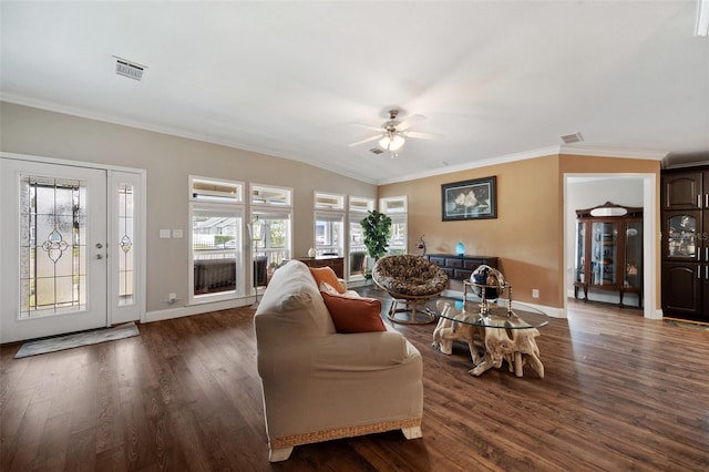 living room featuring ceiling fan, vaulted ceiling, dark hardwood / wood-style flooring, and ornamental molding