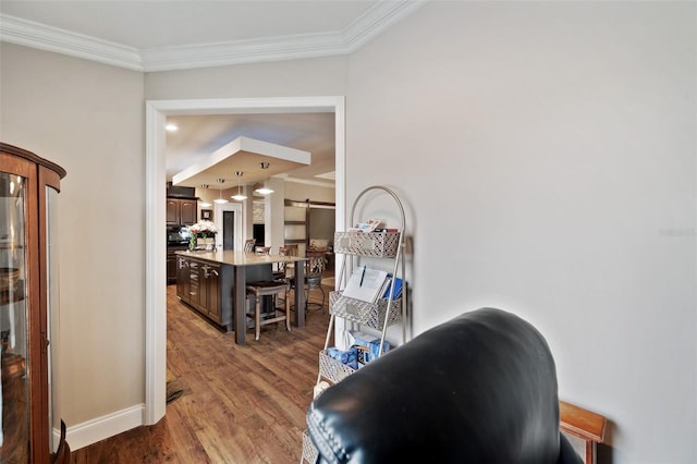 corridor featuring ornamental molding and dark hardwood / wood-style floors