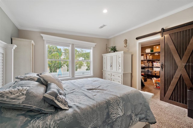 bedroom featuring carpet flooring, ornamental molding, and a barn door