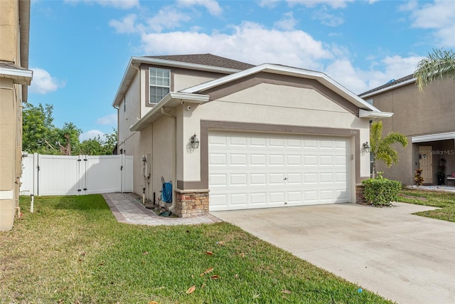 view of front facade featuring a garage and a front lawn