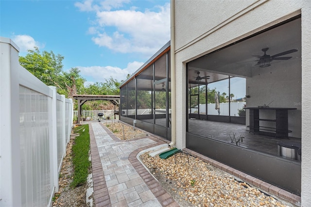 view of patio / terrace with a lanai and ceiling fan