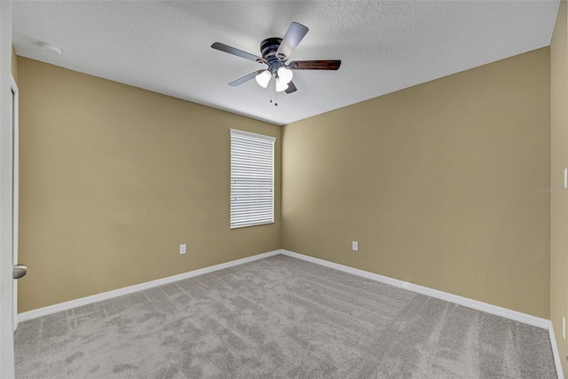 unfurnished room with a textured ceiling, light colored carpet, and ceiling fan