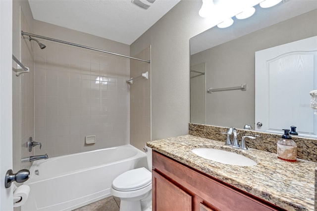 full bathroom with vanity, toilet, tile patterned floors, and tiled shower / bath