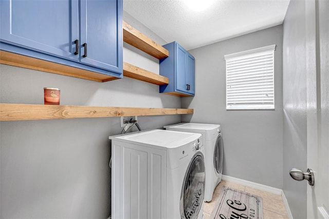 laundry room with cabinets, separate washer and dryer, a textured ceiling, and light tile patterned floors