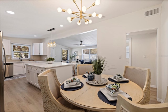 dining area featuring recessed lighting, ceiling fan with notable chandelier, visible vents, vaulted ceiling, and light wood-type flooring