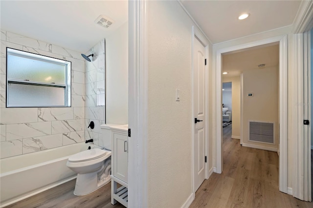 full bath with shower / tub combination, visible vents, wood finished floors, and vanity