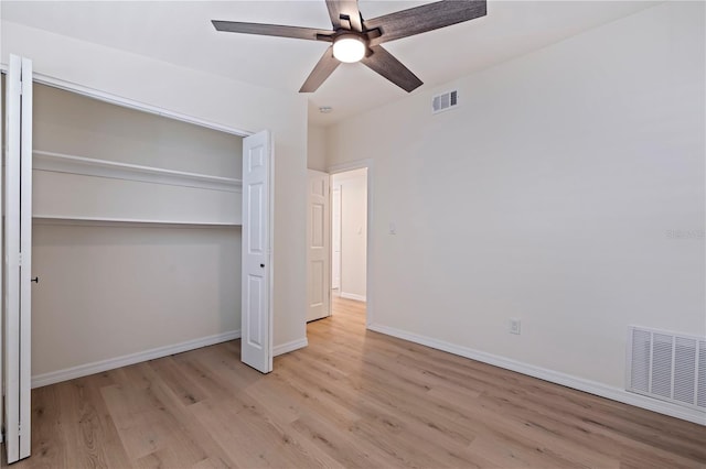 unfurnished bedroom featuring a closet, visible vents, baseboards, and light wood finished floors