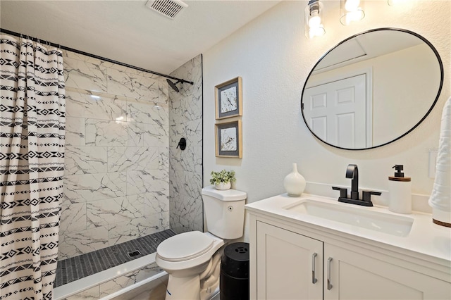 bathroom featuring visible vents, a textured wall, toilet, vanity, and a shower stall