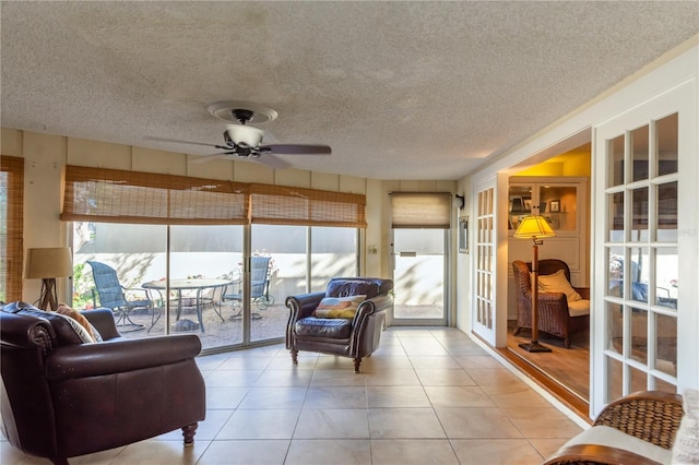 sunroom / solarium featuring ceiling fan