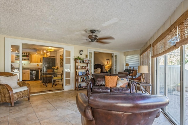 living room with ceiling fan and a textured ceiling