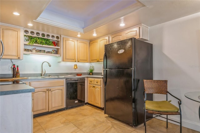 kitchen featuring light brown cabinetry, black appliances, and a raised ceiling