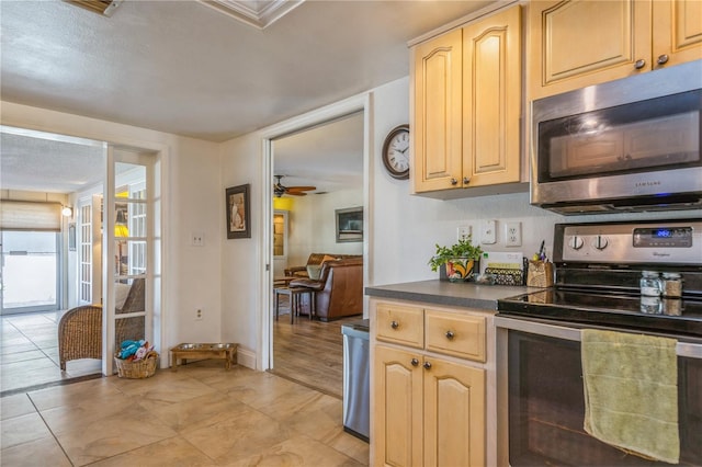 kitchen with ceiling fan, light tile patterned floors, light brown cabinets, and appliances with stainless steel finishes