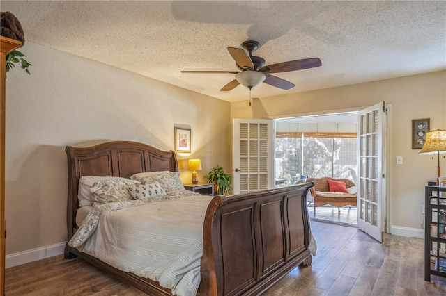 bedroom featuring ceiling fan, dark wood-type flooring, and a textured ceiling