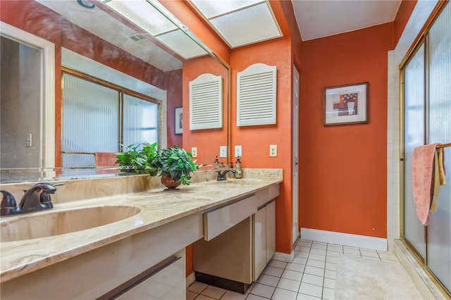 bathroom with vanity, a shower with door, and tile patterned floors