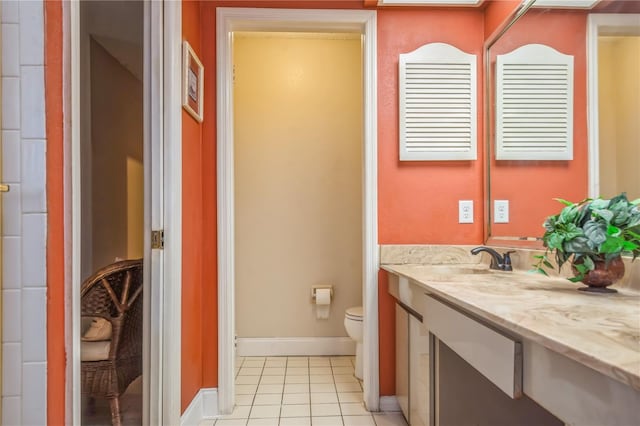 bathroom with tile patterned floors, vanity, and toilet