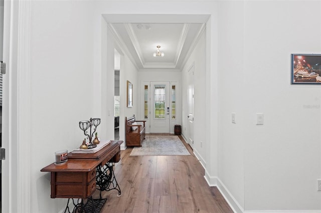 doorway featuring hardwood / wood-style floors and crown molding