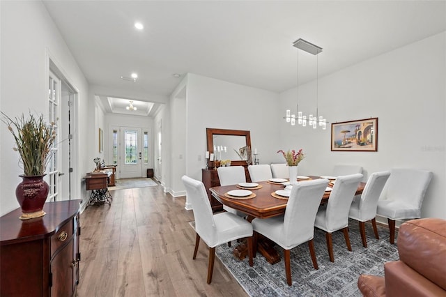 dining area featuring an inviting chandelier and light hardwood / wood-style floors