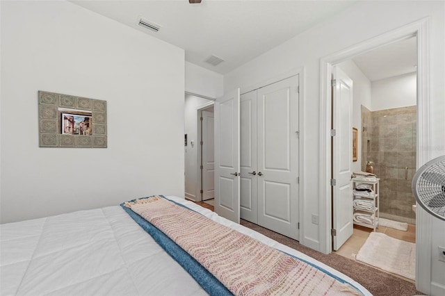 carpeted bedroom featuring a closet and ensuite bathroom