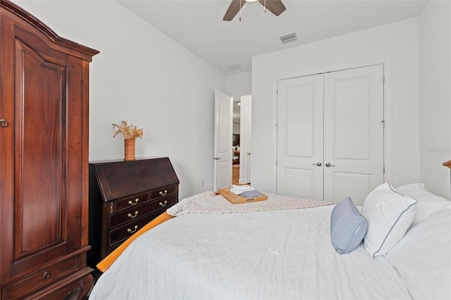 bedroom with ceiling fan and a closet