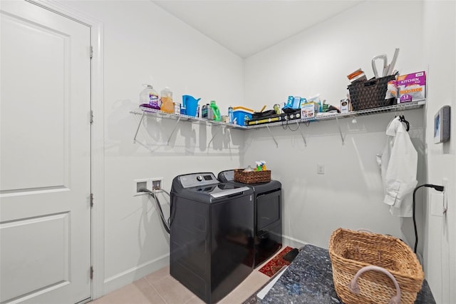 washroom with washer and clothes dryer and light tile patterned floors