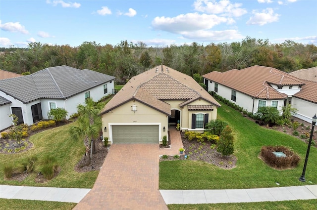 mediterranean / spanish-style home with a garage and a front yard