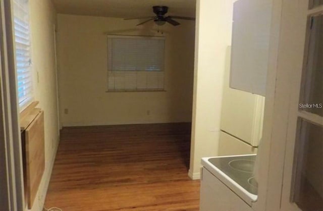 hallway with hardwood / wood-style floors