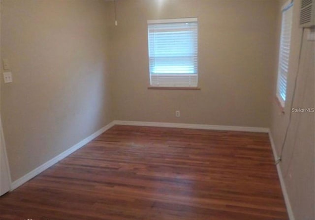 spare room featuring dark hardwood / wood-style flooring