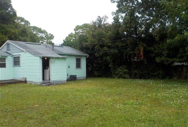 rear view of house featuring a yard