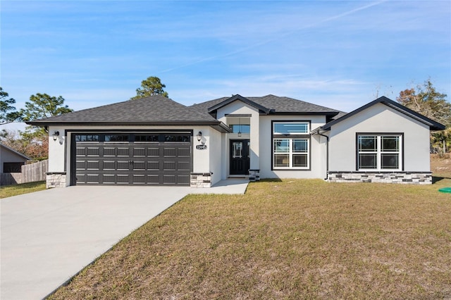 view of front of home featuring a garage and a front yard