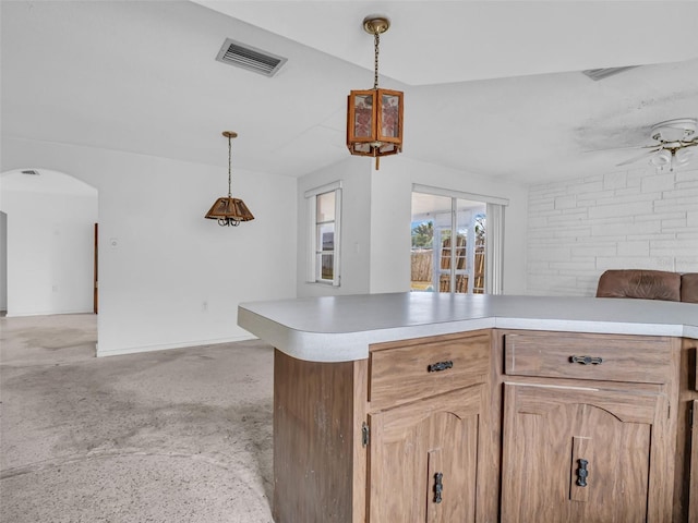 kitchen featuring pendant lighting, ceiling fan, light brown cabinetry, and kitchen peninsula