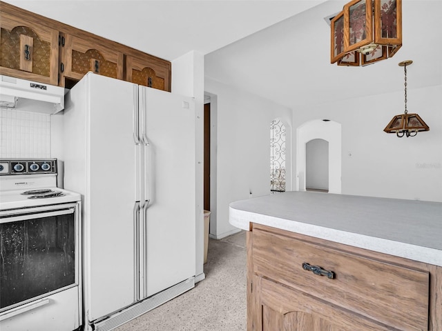 kitchen featuring pendant lighting and white appliances