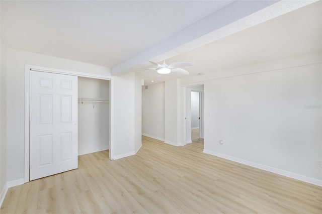 unfurnished bedroom featuring ceiling fan, light hardwood / wood-style floors, and a closet