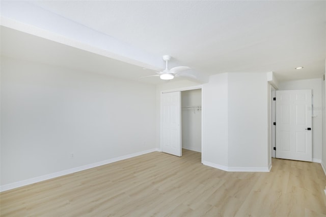 unfurnished bedroom featuring ceiling fan, a closet, and light hardwood / wood-style floors