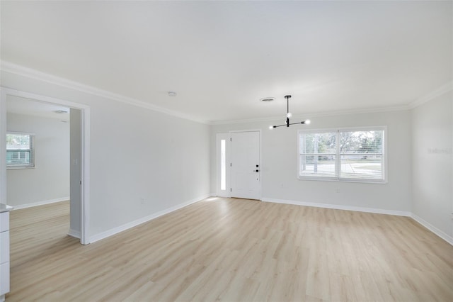 unfurnished living room featuring a healthy amount of sunlight, crown molding, and light hardwood / wood-style flooring