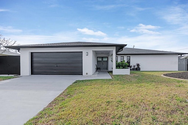 view of front of house with a front yard and a garage