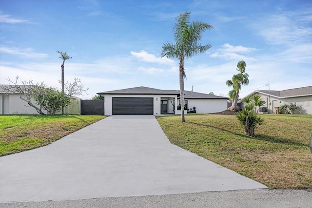 ranch-style house featuring a garage and a front yard