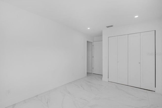 unfurnished bedroom with a closet