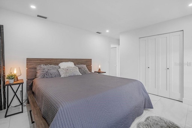 tiled bedroom featuring a closet