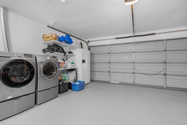 garage with washing machine and dryer and white refrigerator with ice dispenser