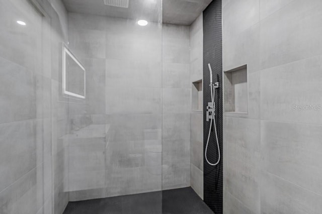 bathroom with tiled shower