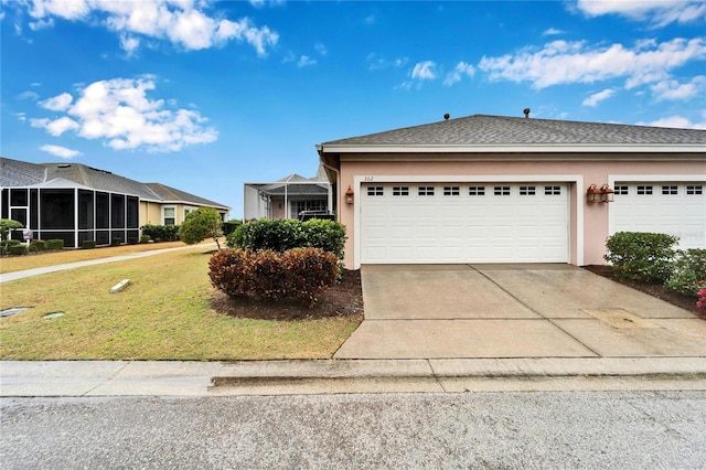 view of front of property featuring a front yard and a garage