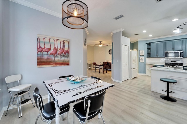 rec room with light wood-type flooring, ceiling fan, and crown molding