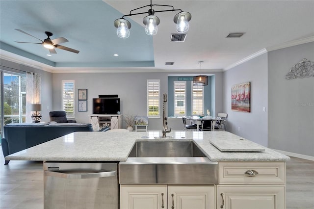 kitchen featuring sink, hanging light fixtures, plenty of natural light, and stainless steel dishwasher