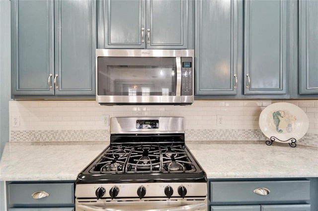 kitchen featuring appliances with stainless steel finishes and decorative backsplash