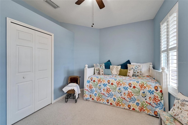 carpeted bedroom with a closet and ceiling fan