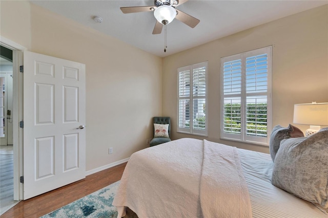 bedroom with ceiling fan and hardwood / wood-style floors