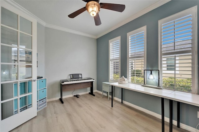 home office with crown molding, a healthy amount of sunlight, and light hardwood / wood-style flooring