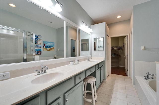 bathroom featuring vanity, independent shower and bath, and tile patterned floors