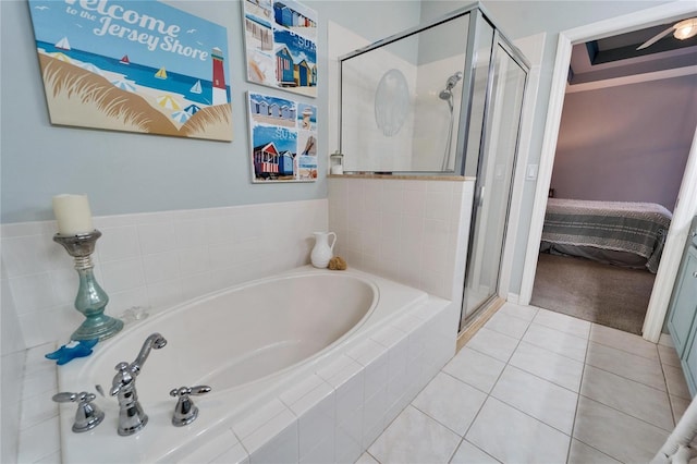 bathroom featuring tile patterned flooring and shower with separate bathtub